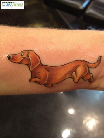 Fun cartoon style tattoo of red dachshund